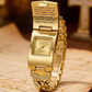 Eine sommerlich anmutende Uhr, verziert mit einem funkelnden Kristallkreuz, einem geometrischen rechteckigen Zifferblatt und einem hochwertigen Metallarmband – eine elegante Wahl für jeden Tag.